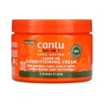 Pot orange vif de 340 g de la Crème Revitalisante Après-Shampoing Sans Rinçage Cantu, idéale pour les boucles, les ondulations et les frisottis naturels. L'étiquette souligne ses bienfaits adoucissants et réparateurs anti-casse. Dakar