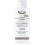 Un flacon de 250 ml de Shampoing Extra-Doux Haute Tolérance Eucerin DermoCapillaire, non parfumé pour cuirs chevelus très sensibles, présente une formule inspirée d'Evashair et un emblème vert avec une revendication 100%. Dakar
