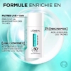Image d'un flacon de fluide anti-UV Bright Reveal de L'Oréal Paris. L'arrière-plan est bleu sarcelle clair avec des gouttes d'eau. Le texte met en valeur les ingrédients : filtres UVB et UVA, 2 % de niacinamide, LHA et vitamine E, pour une protection et des bienfaits exfoliants accrus. Dakar