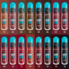 Seize tubes de gloss NYX Lip Lingerie sont disposés sur deux rangées, chacune étiquetée avec un numéro de 01 à 16. Les tubes ont des bouchons turquoise et différentes nuances de rouge à lèvres. Dakar