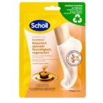 Le masque nourrissant Scholl Chaussettes, présenté dans un emballage jaune orné d'un pied dans un masque blanc façon chaussette, met en avant les bienfaits hydratants du miel de Manuka. Le texte et les pictogrammes des allégations produit sont en allemand. Un coin supérieur indique un emballage recyclable, similaire à celui de la Crème Pieds Onguent Réparateur Scholl. Dakar