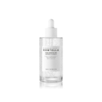 Un flacon compte-gouttes transparent étiqueté « SKIN1004 Madagascar Centella Tone Brightening Ampoule Éclat Correcteur Anti Tache 100 ml », contenant un liquide transparent avec des capsules suspendues. Dakar