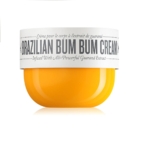 La crème brésilienne Bum Bum de Sol de Janeiro, crème raffermissante et lissante fesses et hanches de 240 ml, est présentée dans un pot à la base jaune vif et au couvercle blanc, au design épuré et moderne. L'étiquette met en valeur son infusion d'extrait de guarana. Dakar