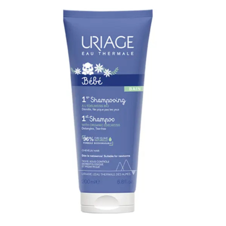 Tube bleu d'Uriage Bébé 1er Shampooing avec bouchon blanc. L'étiquette présente un petit ours et un texte soulignant la présence de 96 % d'ingrédients d'origine naturelle. Flacon : 200 ml. Dakar