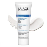 Un tube de Crème Isolante Réparatrice Uriage Bariéderm est présenté sur fond blanc. La crème est présentée glissée à côté du tube. L'emballage souligne ses propriétés isolantes, réparatrices et protectrices pour les peaux fragilisées ou stressées. Dakar