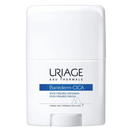Un flacon cylindrique blanc contenant le stick Uriage Bariéderm-CICA, avec une inscription indiquant qu'il s'agit d'un produit pour les crevasses et les fissures. L'étiquette porte les mentions « Eau Thermale » et « L'Eau Thermale des Alpes ». Dakar