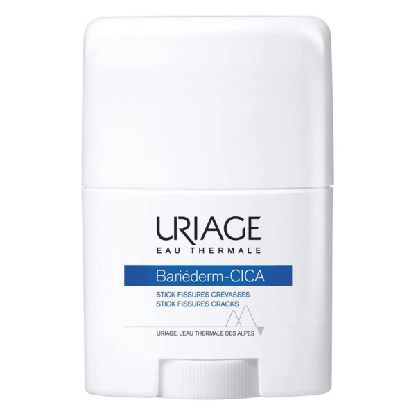 Un flacon cylindrique blanc contenant le stick Uriage Bariéderm-CICA, avec une inscription indiquant qu'il s'agit d'un produit pour les crevasses et les fissures. L'étiquette porte les mentions « Eau Thermale » et « L'Eau Thermale des Alpes ». Dakar