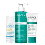 Trois soins Uriage : un stick solaire Bariésun SPF 100, un grand flacon pompe Gel Nettoyant Hyséac 500 ml et un tube Soin Global Hyséac 3-Regul 40 ml, tous au packaging bleu canard et blanc. Dakar