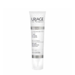 Un tube blanc et argent d'Uriage Dépiderm Soin Contour des Yeux Éclat. Son emballage, en français et en anglais, souligne son efficacité pour illuminer et atténuer les cernes et les poches. Dakar
