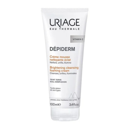 Un tube de Crème Moussante Nettoyante Éclat Uriage Dépiderm à la Vitamine C, conçu pour les teints ternes et tous types de peaux. Ce tube blanc avec inscriptions noires et orange contient 100 ml. Dakar