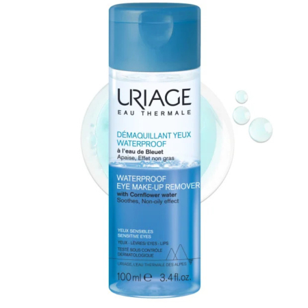 Flacon de Démaquillant Yeux Waterproof Uriage avec bouchon et étiquette bleus. Un texte en français et en anglais décrit ses effets apaisants et non gras à l'eau de bleuet, adaptés aux yeux sensibles. Contenance : 100 ml. Dakar