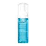 Un flacon d'Eau Thermale Mousse Nettoyante Uriage à l'extrait d'Edelweiss bio. Le flacon bleu transparent avec pompe blanche contient 150 ml de produit. Dakar