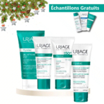 Présentation des produits de soin Uriage Hyseac, comprenant un gel nettoyant, des émulsions, un fluide, un masque exfoliant et des échantillons. Les emballages sont bleu sarcelle et blanc. En haut à gauche, des décorations de Noël avec feuillage vert et étoiles sont exposées. Dakar