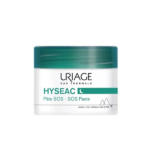 Un flacon de pâte SOS Hyseac d'Uriage Eau Thermale. Le pot est doté d'un couvercle turquoise et d'un corps blanc avec un texte vert et noir. Un petit motif de montagnes est visible en bas à droite. Dakar