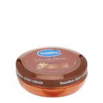 Un pot rond et marron de crème pour le corps Vaseline Cocoa Glow est présenté. Le couvercle arbore le logo Vaseline et le nom du produit, soulignant la présence de beurre de cacao. Dakar