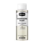 Un flacon transparent de shampoing doux WAAM Paris avec un bouchon argenté. L'étiquette, en français et en anglais, souligne sa certification biologique et son adéquation à tous les types de cheveux. Le texte indique sa neutralité et sa polyvalence. Dakar