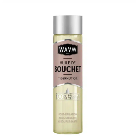 Un flacon transparent étiqueté « WAVM Paris Huile de Souchet Tigernut Oil » avec un bouchon argenté. L'étiquette indique également « 100% Pure et Végétale » et mentionne « Post-Épilation Adoucissante Assouplissante. Dakar