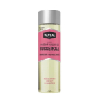 Un flacon transparent de macérat huileux de busserole WAVM Paris, avec un bouchon argenté et une étiquette rose. L'étiquette présente un texte en français et en anglais décrivant ce produit comme rééquilibrant, unifiant et illuminant. Dakar