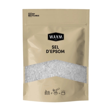 Un emballage beige étiqueté « Sel d'Epsom » de WAAM Paris, avec une section transparente laissant apparaître du sel d'Epsom blanc à l'intérieur. L'emballage mentionne le caractère recyclable du produit et comporte de petites icônes d'utilisation suggérées en bas. Dakar