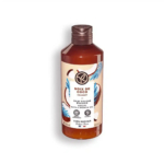 Un flacon marron et transparent de gel douche et bain Noix de Coco Yves Rocher, orné d'un motif tropical, avec des feuilles bleues et marron et une découpe en forme de noix de coco sur l'étiquette. Le bouchon marron est orné d'un texte en français et en anglais. Dakar