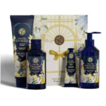 Un coffret cadeau comprenant la collection Vanille d'Orchidée d'Yves Rocher, comprenant une lotion pour le corps, un gel douche et un parfum, le tout dans un emballage bleu foncé aux accents floraux, placé devant une boîte cadeau décorative avec un ruban. Dakar