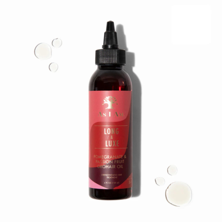 Un flacon d'Asiam Soin Fortifiant Cheveux et Cuir Chevelu avec l'Huile de Ricin 120ml est représenté sur un fond blanc, avec quelques gouttes d'huile placées autour. Dakar