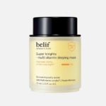Un pot de 75 ml de Belif Masque Hydratant de Nuit Multivitaminé Super Knights présente un couvercle noir et une crème jaune, conçus pour améliorer la clarté de la peau pendant la nuit. Comparable au Medicube Masque de Nuit au Collagène. Dakar