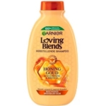 Un flacon de 300 ml de Garnier Shampoing Nourrissant et Réparatrice Loving Blends Miel Or, avec une étiquette en nid d'abeille orange et un texte en français, conçu pour nourrir et réparer les cheveux abîmés. Dakar