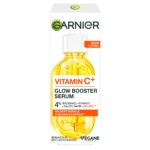 Vue de face d'une boîte de Garnier Skinactive Sérum Anti Tache à la Vitamine C avec un flacon compte-gouttes de liquide jaune. L'emballage met en avant la niacinamide, l'acide salicylique, le Melasy™, et revendique une réduction visible des taches brunes. Dakar