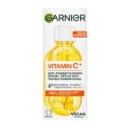Une boîte de Garnier Skinactive Sérum Anti Tache à la Vitamine C, avec une image de flacon compte-gouttes, une étiquette végétalienne et des détails mettant en évidence 4 % de niacinamide, de vitamine C et de mélasyl pour aider à réduire les taches brunes. Dakar
