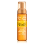 Un flacon de Crème of Nature Pure Honey Mousse Coiffante pour Boucles 207 ml avec un bouchon pompe doré, étiqueté pour les cheveux secs et déshydratés et enrichi d'ingrédients clés pour définir et hydrater les boucles. Dakar