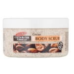 Un pot blanc de 200 g de Gommage Corporel Palmer's au Beurre de Cacao et à la Vitamine E, avec des fèves de cacao et les informations produit sur l'étiquette. Ce gommage onctueux exfolie pour une peau plus lisse et nourrie. Dakar