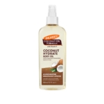 Un flacon pulvérisateur en plastique transparent de 150 ml d'huile corporelle à l'huile de coco Palmer's, orné d'un motif et d'une image de la noix de coco, est présenté à côté de l'huile corporelle Vaseline Intensive Care Cocoa Radiant. Sa formule de 150 ml hydrate la peau en profondeur. Dakar
