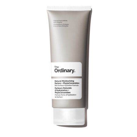 Un tube argenté et blanc de The Ordinary Crème Visage Facteurs Naturels d'Hydratation PhytoCéramides 30 ml se dresse debout sur un fond blanc, avec les détails du produit en anglais et en français sur l'étiquette. Dakar