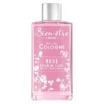 Un flacon rose de 250 ml de L'Original Eau de Cologne Rose, orné de motifs floraux blancs et d'un bouchon argenté. Le texte sur le flacon met en avant le géranium et l'ylang comme notes principales. Dakar