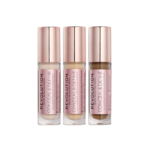 Trois flacons de Makeup Revolution Conceal and Define Correcteur Liquide Visage et Contour Yeux 4g, chacun avec un bouchon or rose, se trouvent côte à côte. Les teintes vont de claires à profondes, avec des étiquettes roses et un texte noir en gras. Dakar