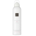 Un flacon blanc de The Ritual of Sakura Mousse de Douche 200 ml, doté d'un logo argenté et d'un texte rose, offre un mélange de parfums luxueux de lait de riz et de fleur de cerisier. Dakar