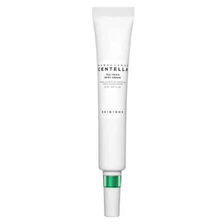 Un tube blanc de Skin1004 Crème anti-taches Centella Tea-Trica de Madagascar 20 ml, doté d'un bouchon aux accents verts, est présenté à la verticale sur un fond blanc uni. Dakar