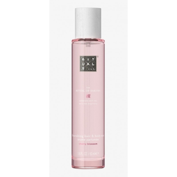 Un grand flacon cylindrique rose de The ritual of sakura brume corps et cheveux 50ml, étiqueté fleur de cerisier, avec un bouchon argenté et un design minimaliste. Dakar