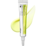 Un tube de Celimax The Vita A Retinal Shot Raffermissant Anti Pores Dilates Rides et Ridules Peau plus Ferme 15 ml, avec un bouchon argenté, repose au-dessus d'une couche lisse de crème jaune clair et d'informations détaillées sur le produit. Dakar