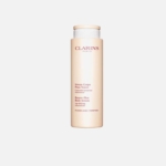 Un flacon de sérum corporel Renew-Plus de Clarins, de couleur pêche, avec un bouchon beige, se tenant debout sur un fond blanc uni. Le flacon comporte un texte rouge détaillant le nom et la description du produit. Dakar