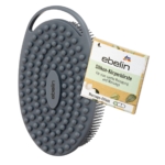 La Brosse Corporelle en Silicone 1 pièce d'Ebelin est une brosse corporelle ovale en silicone de couleur grise avec des poils courts et un manche, présentée à côté de son emballage pour un nettoyage et un massage en douceur. Dakar
