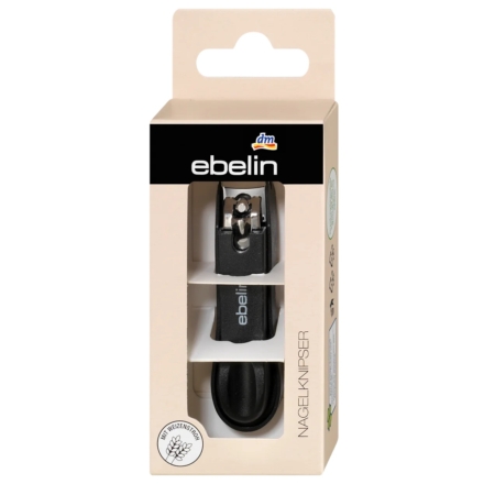 Un coupe-ongles Ebelin Coupe Ongles 1 Pièce noir est présenté dans une boîte beige avec une fenêtre transparente. La marque et les détails du produit sont imprimés sur l'emballage. Dakar