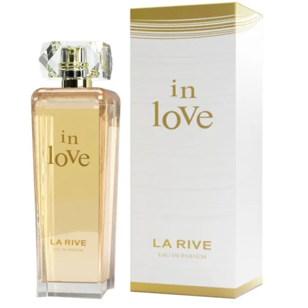 Le flacon en verre transparent de La Rive In Love Eau de Parfum 90 ml avec un bouchon à facettes se trouve à côté de son coffret blanc et or assorti, tous deux ornés d'élégantes lettres dorées pour un look raffiné. Dakar