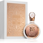 Un flacon de parfum rond au design or rose et blanc est placé devant une boîte ornée d'écritures arabes, tous deux étiquetés "Lattafa Yara Candy Eau de Parfum pour femme 100ml (Copie)"-exemptant d'élégance et de style. Dakar