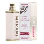 Un flacon de Makari Lait de Beauté Éclaircissant pour le Corps Premium Plus 140ml se trouve à côté de sa boîte, tous deux avec des accents dorés et roses et étiquetés "Premium+" avec "Lait de Beauté Éclaircissant". Dakar