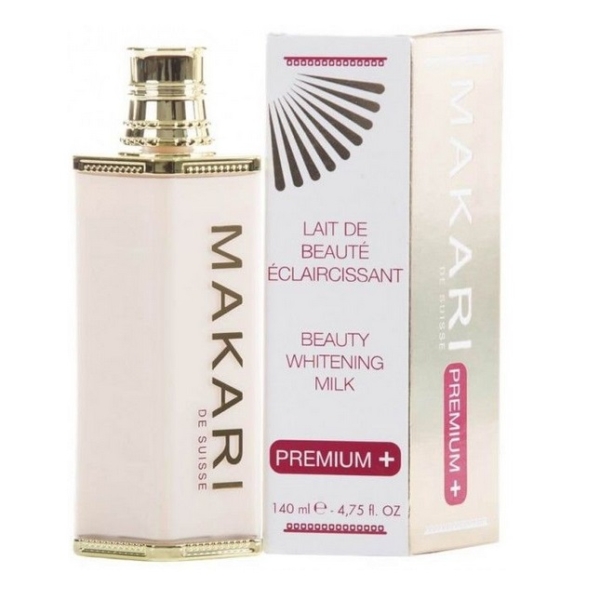 Un flacon de Makari Lait de Beauté Éclaircissant pour le Corps Premium Plus 140ml se trouve à côté de sa boîte, tous deux avec des accents dorés et roses et étiquetés "Premium+" avec "Lait de Beauté Éclaircissant". Dakar