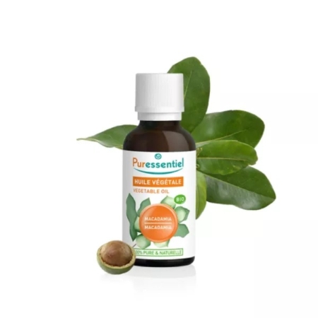 Un flacon de Puressentiel Huile Végétale Bio Macadamia 100% Pure et Naturelle 50ml est présenté avec des feuilles de macadamia vertes et une noix coupée en deux, mettant en valeur ses ingrédients naturels et sa qualité supérieure. Dakar