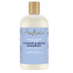 Flacon transparent de 384 ml de Shea Moisture Miel de Manuka et Yaourt Shampoing Hydratant et Réparateur avec un bouchon doré et une étiquette bleu clair, conçu pour les cheveux extrêmement secs et cassants. Dakar