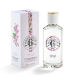 Un flacon transparent de Roger et Gallet Feuille de Thé Eau de parfum 100ML avec un bouchon blanc et une étiquette ronde en texte noir se trouve à côté de sa boîte florale blanche et rose. Dakar